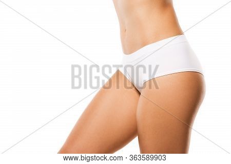 Beautiful Female Legs, Buttlocks And Belly Isolated On White Background. Beauty, Cosmetics, Spa, Dep