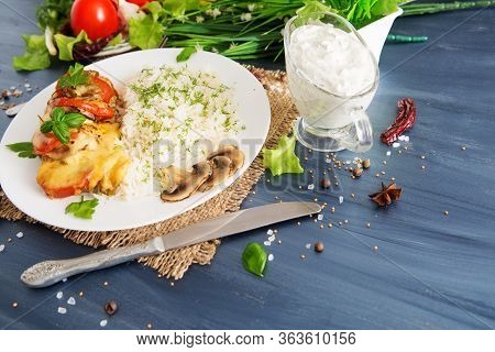 Fired Cordon Bleu Chicken Served With Rice And Parsley On Plate.chicken Fillet Baked In Cheese With 
