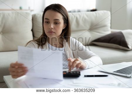 Young Woman Manage Household Finances At Home