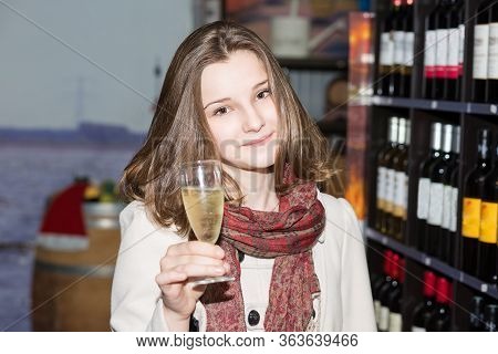 Woman Sniffing And Tasting White Wine In A Glass Giving Cheers Hand Gesture While Looking At You Cam