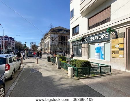 Strasbourg, France - March 16, 2020: Wide Angle View Of Multiple People Waiting In Queue To Enter Th