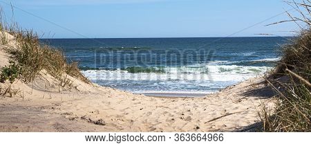 Looking Through The Dunes At The Atlantic Ocean On A Sand Footpath In Montauk New York Long Island U