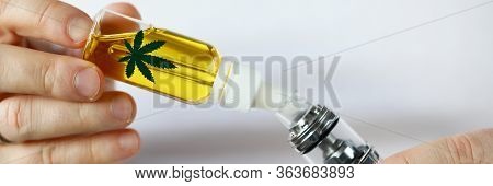 Male Hand Fill Up Liquid Organic Extra Virgin Cannabinoid Oil With Vipe Pen System Against Home Back