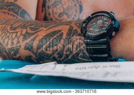 Mens Arm With A Tattoo And A Large Wrist Watch