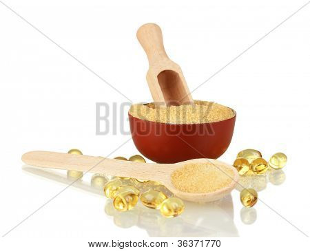 Gelatin in a bowl and wooden spoon on white background close-up
