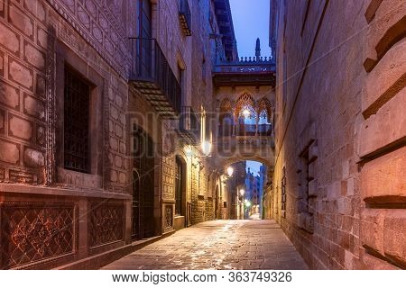 Narrow Cobbled Medieval Carrer Del Bisbe Street With Bridge Of Sighs In Barri Gothic Quarter In The 