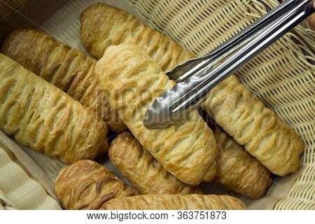 Croissant Buns From Puff Pastry On The Counter Of The Bakery Department In The Store, Take The Bun W