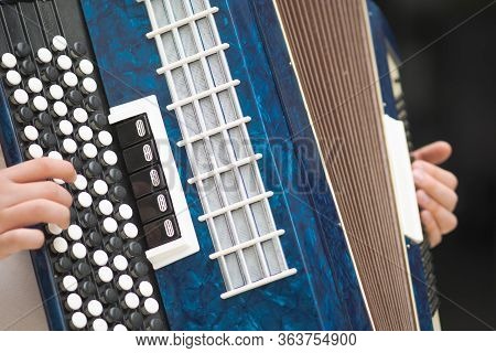 Accordion In The Hands Of A Musician, Close-up View. Street Music Image, Busker Playing A Melodeon
