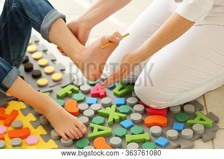 Child Flatfoot Treatment Using Special Massage Carpet.little Girl On Massage Mat Doing Exercises For