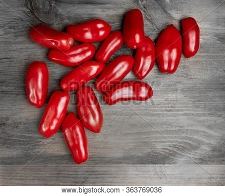 Shiny Red San Marzano Tomatoes (solanum Lycopersicum). Lucullus Type Italian Tomatoes On A Wood Tabl