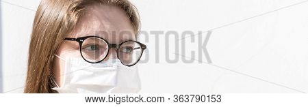 Close Up Of A Millennial Girl Wearing Mask, Is Looking With Hope On A White Background, Web Banner