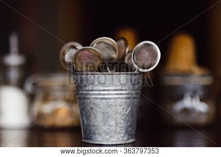 Tea Strainers In A Zinc Bucket On A Bar Counter