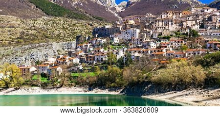 traditional Italy. Beautiful emerald lake in Abruzzo mountains and scenic village. Lago di Barrea