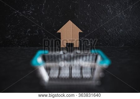 Real Estate Market And Buying A Property, House Icon Iand Shopping Basket Symbol Of Homebuyers