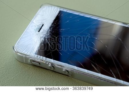 Broken Glass Screen Smartphone. Work Of Service Center Showing Smartphone While Using Protection Scr