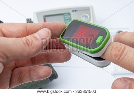 Pulse Oximeter, Finger Digital Device To Measure Person`s Oxygen Saturation. Close-up. Reduced Oxyge