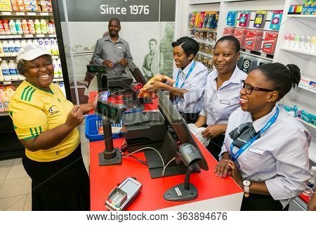 African Cashier And Customer At Checkout At Local Pick N Pay Grocery Store
