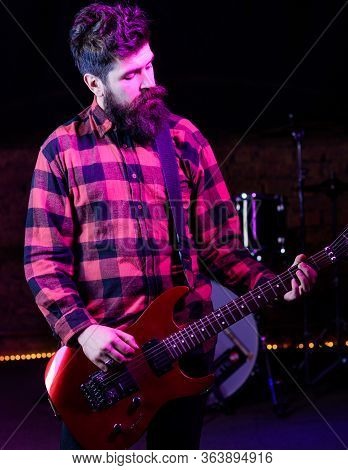 Frontman Concept. Man With Calm Face Holds Guitar, Singing