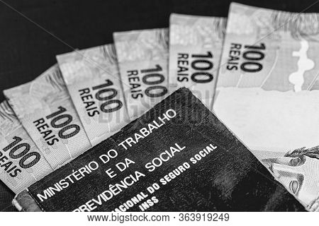 Brazilian Work Card With 100 Reais Bills, Document Written In Portuguese Ministry Of Labor And Socia