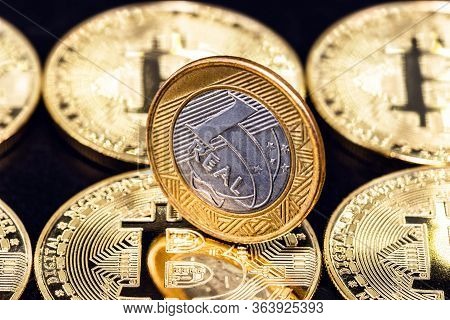 One Real Coin, Money From Brazil, Over Several Bitcoin Currencies. Digital Currency Mining Concept.