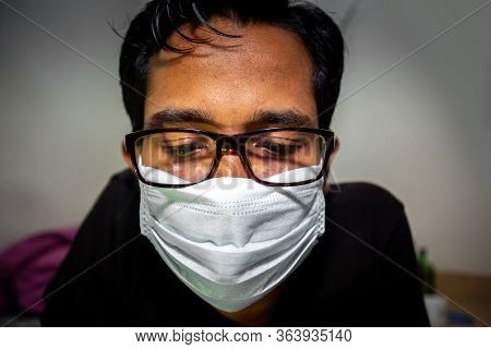 Portrait Of A Young Man Playing Mobile Video Games At Night Due To Coronavirus Epidemic.