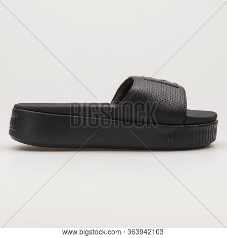 Vienna, Austria - February 19, 2018: Puma Platform Slide Black Sandal On White Background.