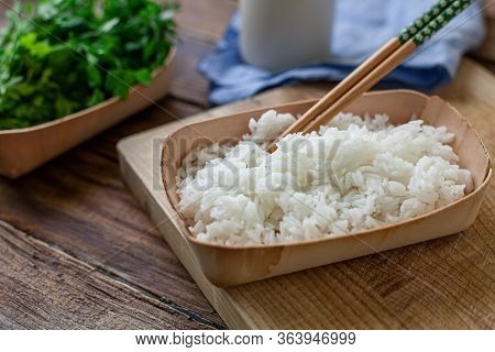 Boiled Rice On A Bambu Bowl With Parsley