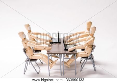 Sitting Face Masked Wooden Dolls Is Having A Meeting In Front Of White Background