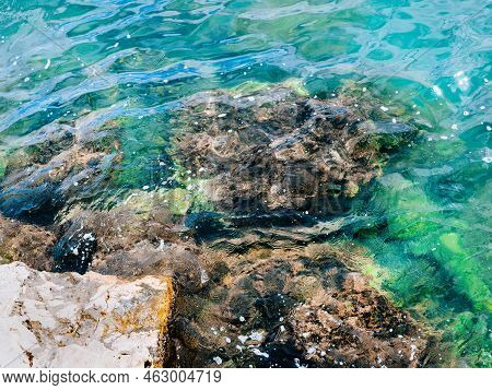 Seashore Stones View. Stones In A Clear Blue Rippeling Water