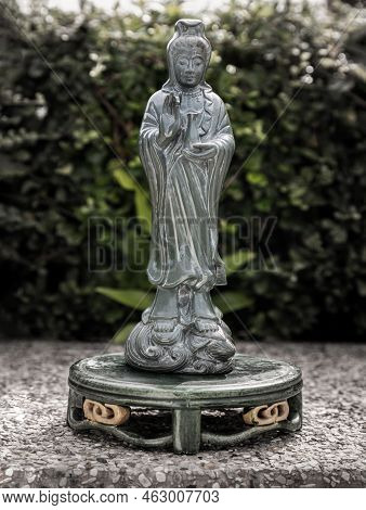 Figurine Of Green Guan Yin Bodhisattva Or Quan Yin Buddha Statue (goddess Of Mercy) With Green Leave