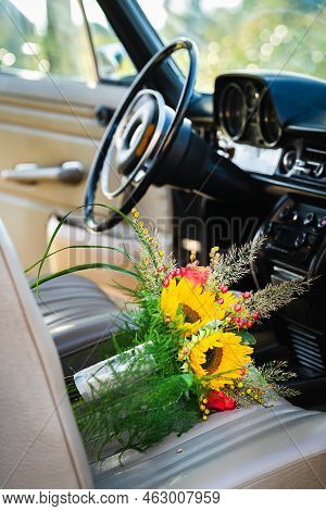 Vintage Wedding Car With Lovely Wedding Bouquet Full Of Roses And Sunflowers