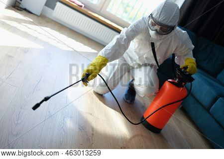 Pest And Virus Bacteria Control Contractor Works In Apartment. Disinfection Of Premises From Insects