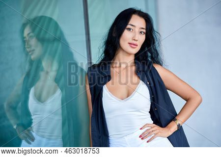 Fashion Close-up Portrait Of Young Woman Posing  Near To Showcase