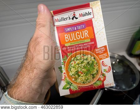 Paris, France - Sep 1, 2022: Pov Male Hand Holding Package With Bio Organic Muller And Muhle Simply 