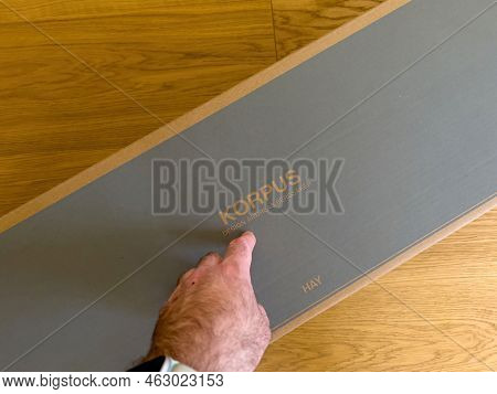 Paris, France - Apr 9, 2022: Pov Male Hand Pointing Before Unboxing To Package With Danish Hay Korpu