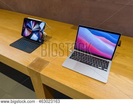 Paris, France - Ap 7, 2022: Apple Computers Macbook Pro Next To Ipad Pro On Wooden Table