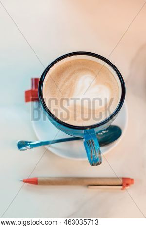 View From Above. Coffee With Milk In A Blue Cup On A Wooden Table In A Cafe