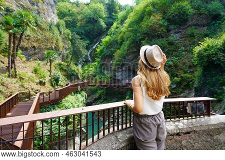 Girl Walking In The Path Enjoying Landscape With Waterfalls And The Gorges Of A Natural Canyon