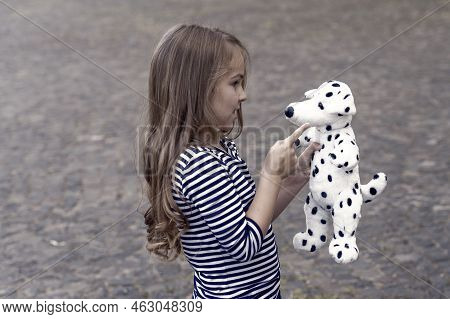 Paying Is State Of Being. Little Child Play With Toy Dog Outdoors. Role Playing. Pretend Play. Child