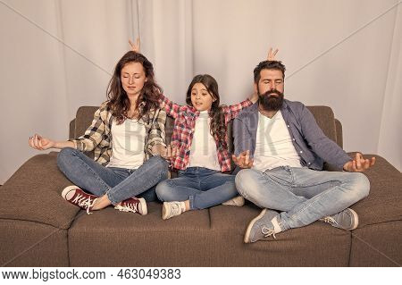 Parents With Kid Maditating Together At Home, Yoga