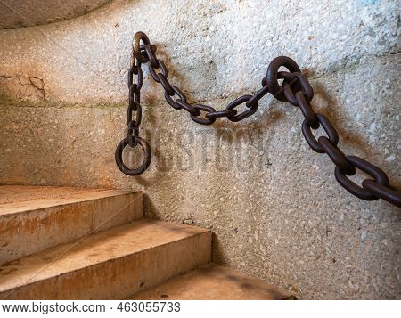 Narbonne, France - September 12, 2022: A Steel Chain Railing By The Circular Staircase Of A Tower In