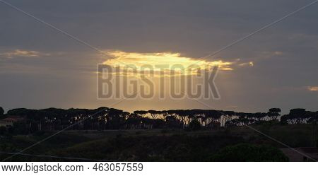 A Wide Angle Cloudscape In Light Orange With Sunrays Passing Throgh The Clouds
