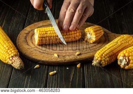 The Chef Cuts The Maize With A Knife. Corn Is An Excellent Dietary Breakfast Or Lunch. Working Envir