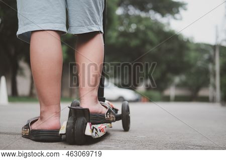 Close Up Of Kid Feet Standing On A Self-balanced Scooter A Back View