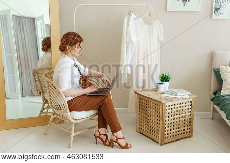 A Business Woman With A Laptop. A Human Design Specialist Works At Home On A Laptop. Work From Home 