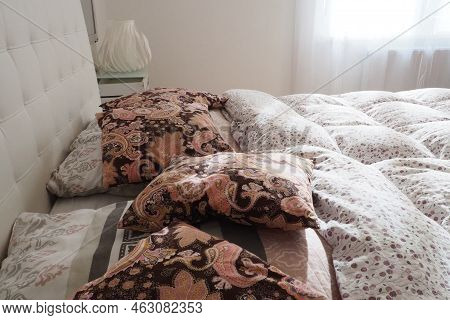 Pink Decorative Pillows On The Bed Linen. Double Bridal Bed With Pillows And Thick Feather Duvet. Be