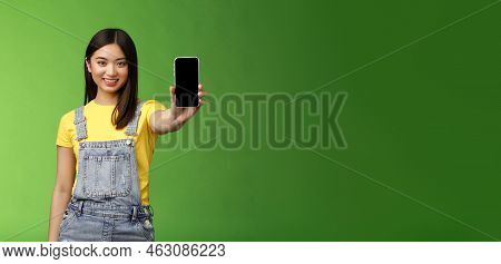 Self-assured Attractive Asian Brunette Show Smartphone Screen, Introduce New Telephone Appllication,