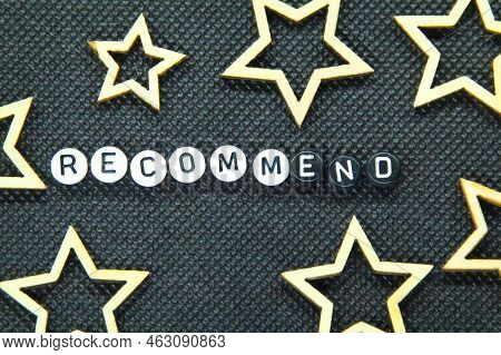 Small White Circle With The Word Recommend On A Dark Background. Business Development Concept