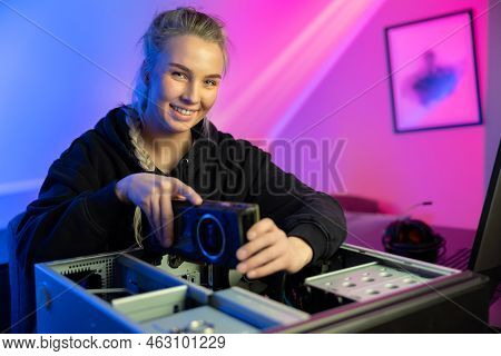 Smiling E-sport Gamer Girl Installing New Gpu Video Card In Her Gaming Pc