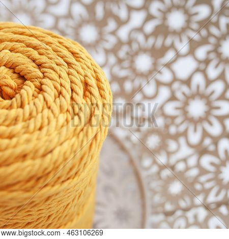 Handmade Macrame Braiding And Cotton Threads On White Textile Background. Yellow Cotton Macrame Cord